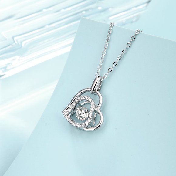 Diamond Heart pendant with a Dancing Moissanite Diamond in the center.